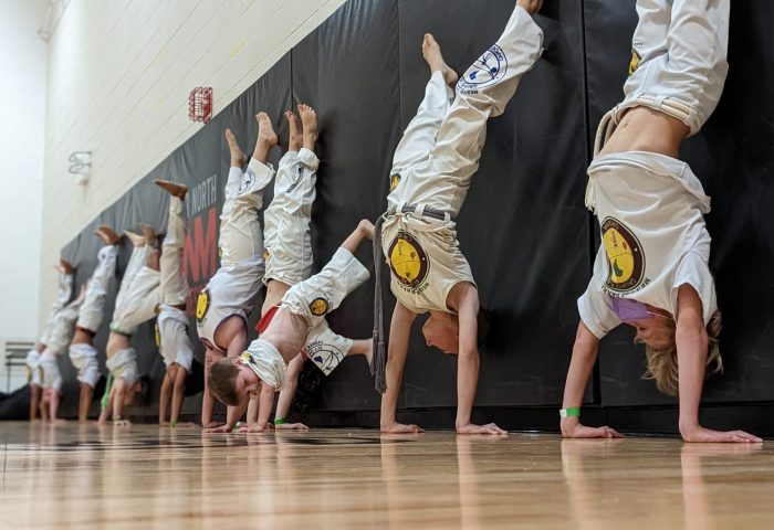 Capoeira students sparring in a roda at Axé Capoeira Chicago